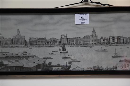 A Chinese machine embroidered silk picture of the river front of Shanghai, 1930s, 18.5 x 84cm., framed and glazed